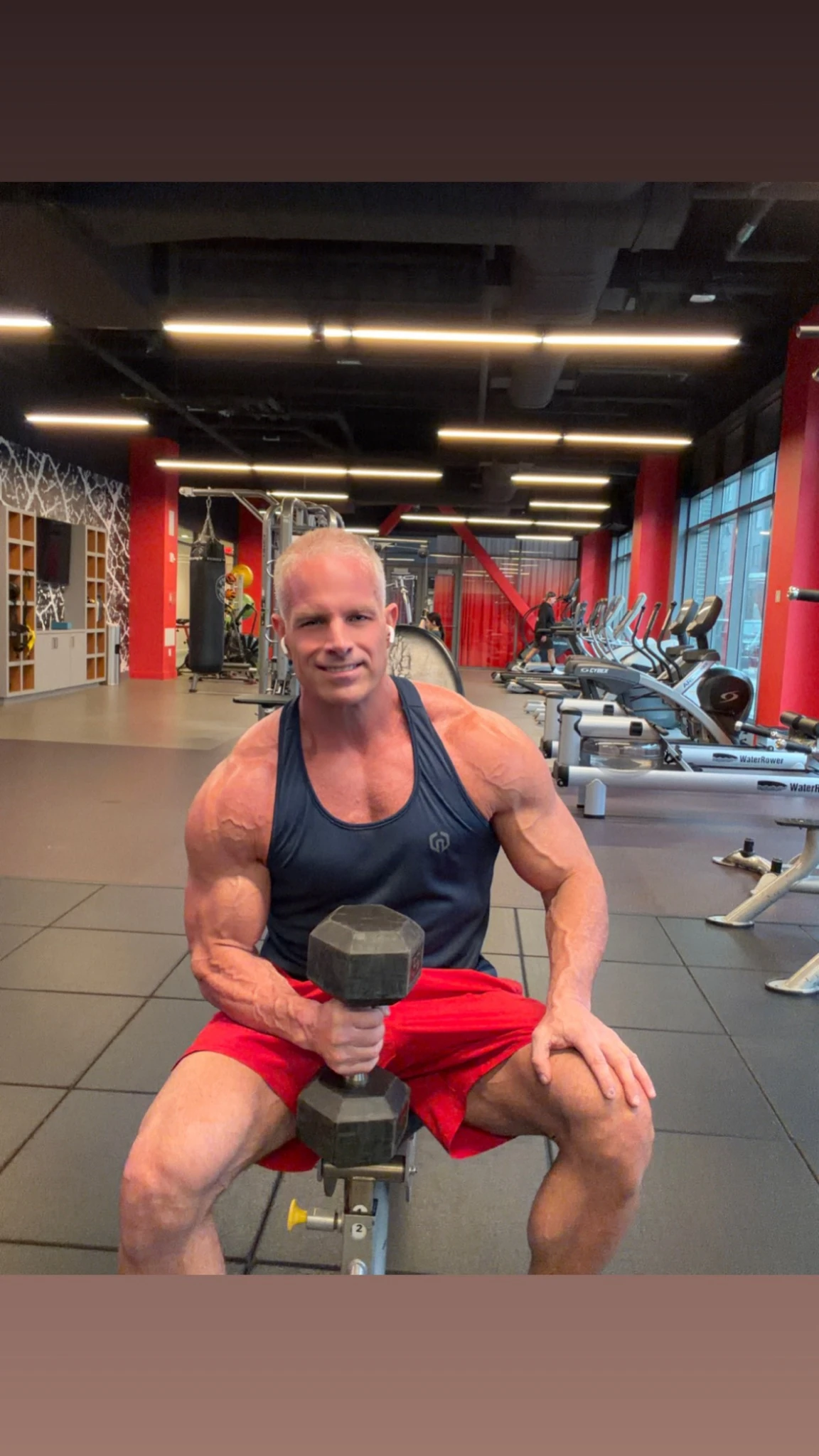 Markus in the gym holding a dumbbell